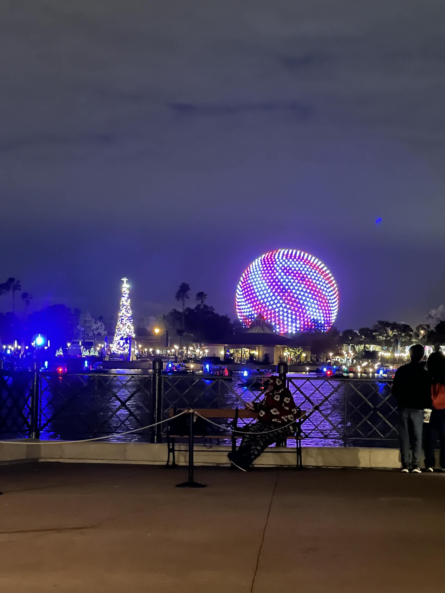 Spaceship Earth glowing at night during Epcot’s holiday season